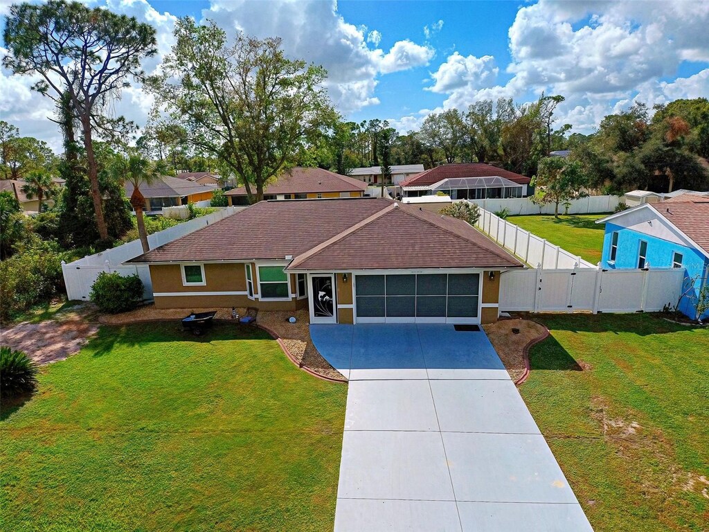 3763 Ribera Ave, North Port, FL 34286 - ranch-style house featuring a garage and a front lawn