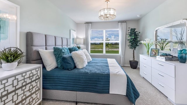 bedroom with light colored carpet and a chandelier