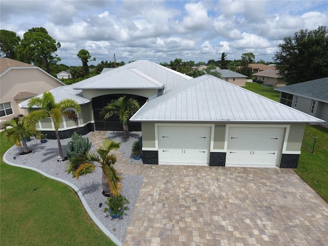 view of front of property with a front yard and a garage