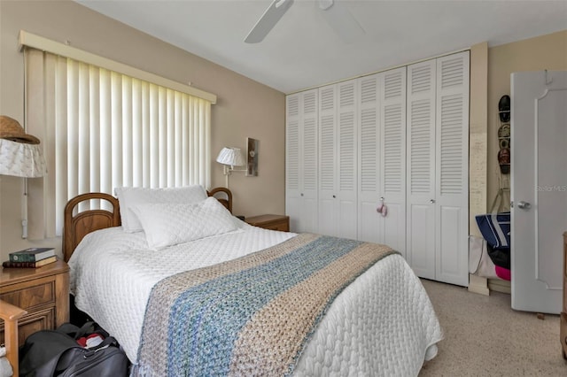 bedroom featuring ceiling fan, light colored carpet, and a closet