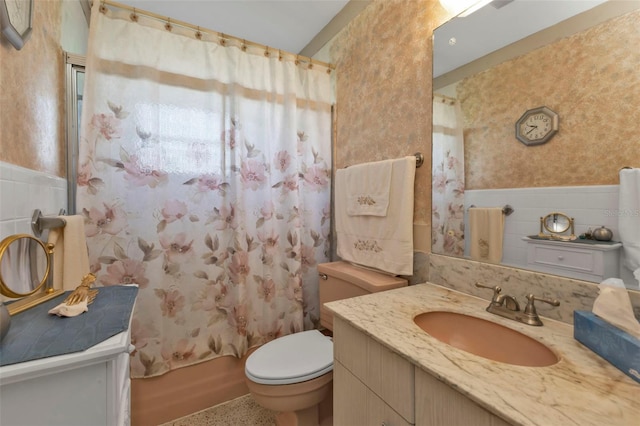 full bathroom featuring vanity, tile walls, shower / tub combo, and toilet