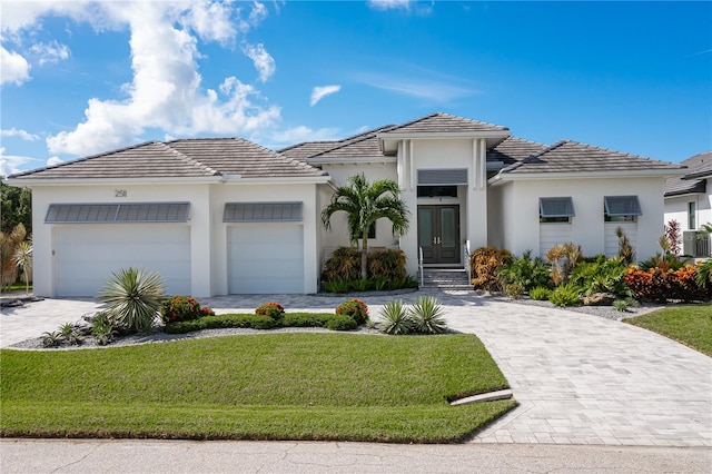 view of front of house with a garage and a front yard