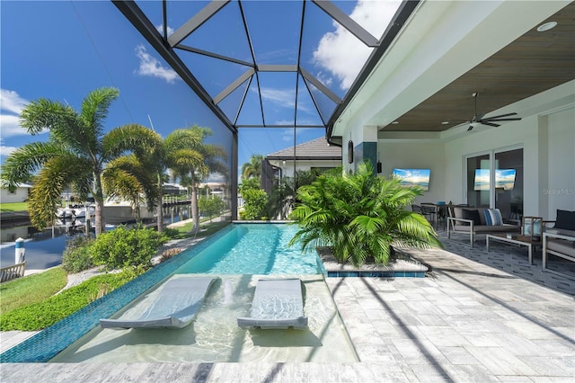 view of swimming pool with a lanai, ceiling fan, and a patio