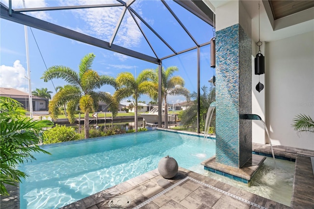 view of pool featuring pool water feature, a patio area, and glass enclosure