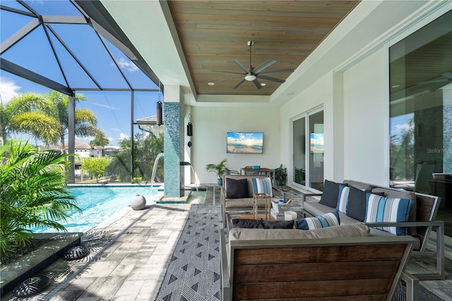 view of patio featuring an outdoor living space, ceiling fan, and a lanai