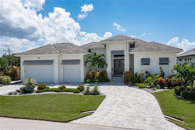 view of front of house featuring a front yard and a garage