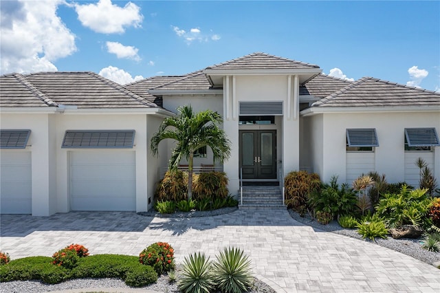 view of front of home featuring a garage and french doors