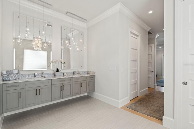 bathroom featuring crown molding, vanity, hardwood / wood-style floors, and a notable chandelier