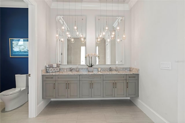 bathroom featuring toilet, crown molding, and vanity