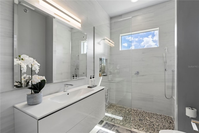 bathroom with vanity and a shower with shower door