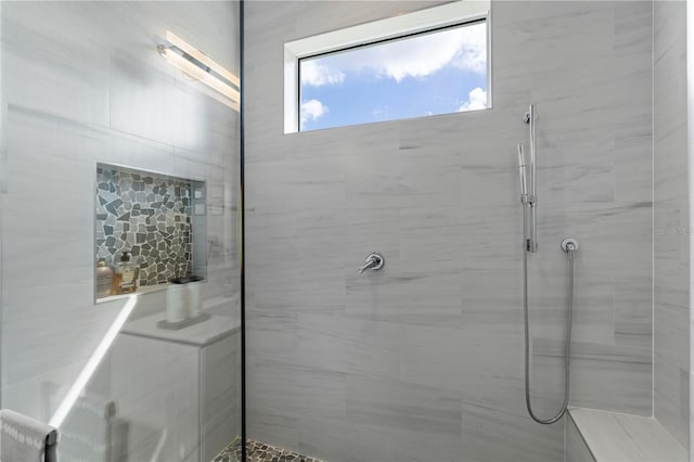 bathroom with a tile shower