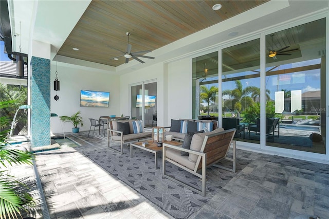 view of patio with an outdoor living space and ceiling fan