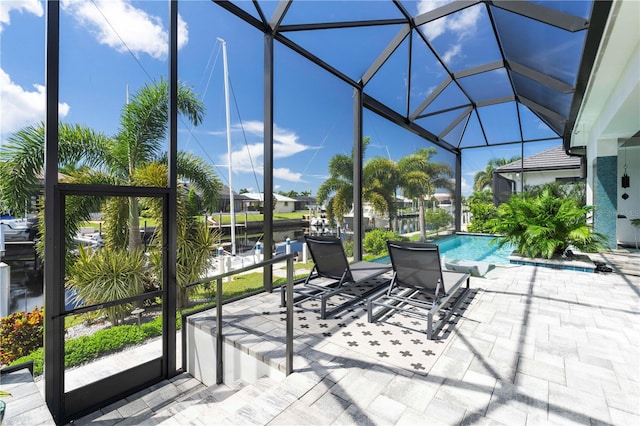 view of patio / terrace with glass enclosure and a water view