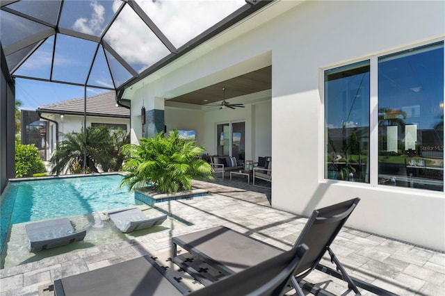 view of pool with glass enclosure, ceiling fan, and a patio