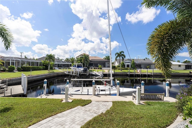 dock area featuring a yard, a water view, and a lanai