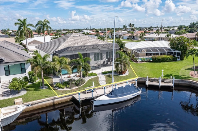 exterior space with a water view, a lawn, a lanai, and a patio area