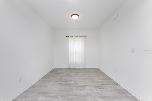 spare room with light hardwood / wood-style flooring