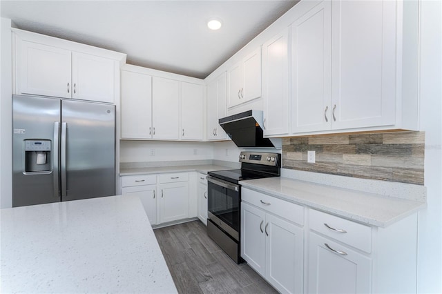 kitchen featuring appliances with stainless steel finishes, tasteful backsplash, light stone counters, white cabinets, and light hardwood / wood-style floors