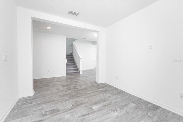 empty room with light hardwood / wood-style flooring