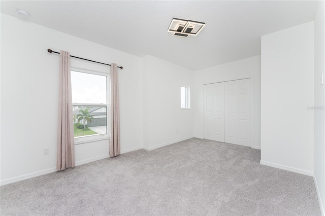 unfurnished room with light carpet