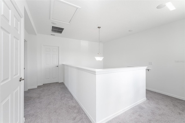 hallway featuring light colored carpet