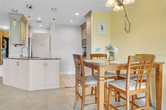 tiled dining area featuring sink