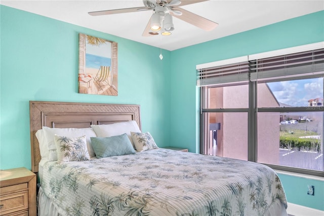 bedroom with multiple windows and ceiling fan