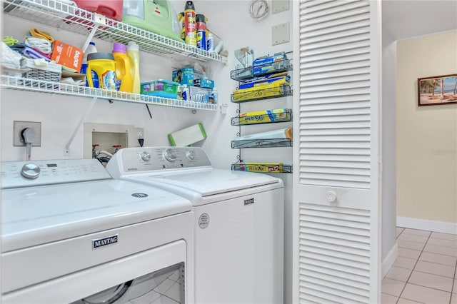 laundry area featuring independent washer and dryer and light tile patterned floors