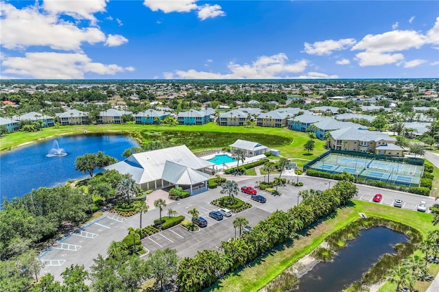 birds eye view of property with a water view and a residential view