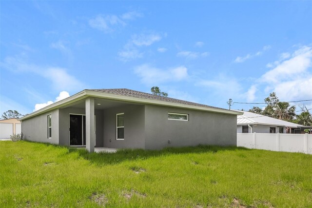 rear view of house featuring a lawn