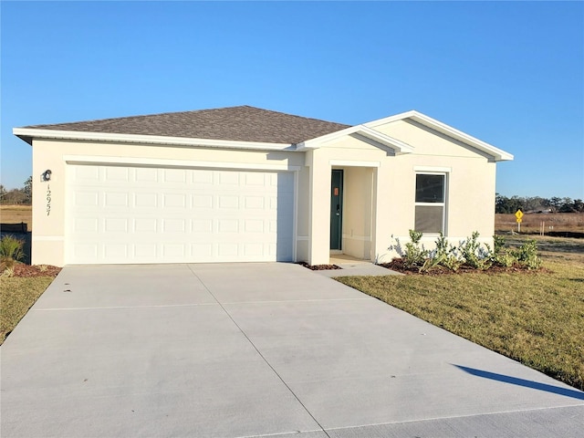 ranch-style home featuring stucco siding, an attached garage, driveway, and a shingled roof