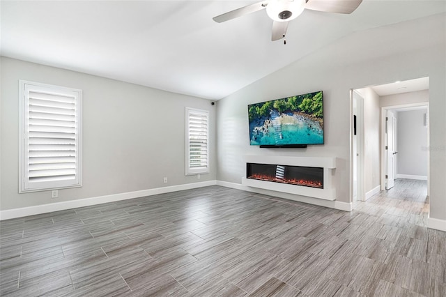 unfurnished living room featuring lofted ceiling, light hardwood / wood-style flooring, and ceiling fan