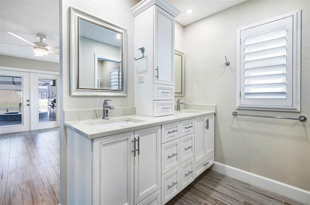 bathroom with vanity, a wealth of natural light, wood-type flooring, and ceiling fan