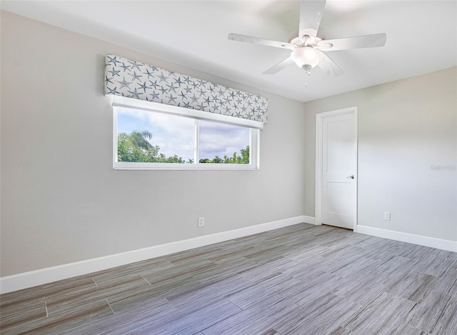 unfurnished room with ceiling fan and wood-type flooring