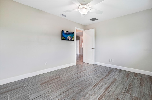 spare room with ceiling fan and wood-type flooring