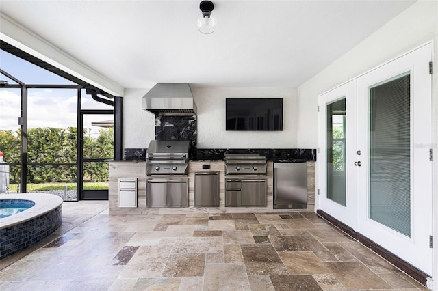 kitchen with stainless steel fridge, wall chimney range hood, and french doors