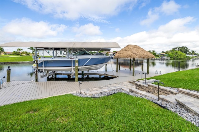 view of dock featuring a lawn and a water view