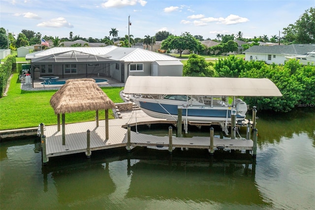 dock area featuring a water view, a lawn, glass enclosure, and a swimming pool