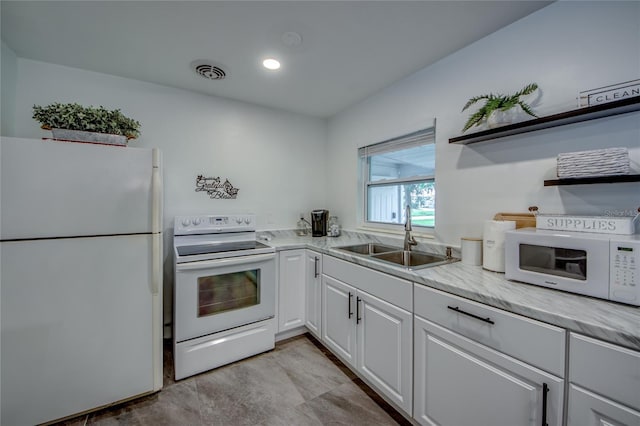 kitchen with a sink, open shelves, white cabinetry, white appliances, and visible vents