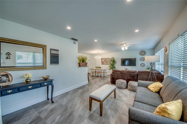 living area featuring a healthy amount of sunlight, baseboards, and recessed lighting