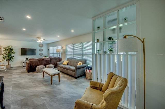 living area with a ceiling fan, visible vents, and recessed lighting