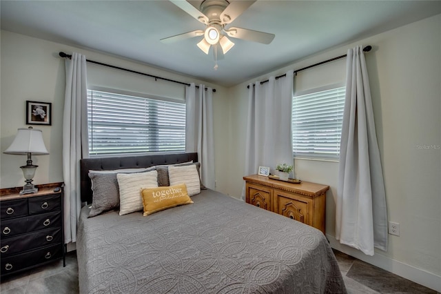 bedroom featuring multiple windows and ceiling fan