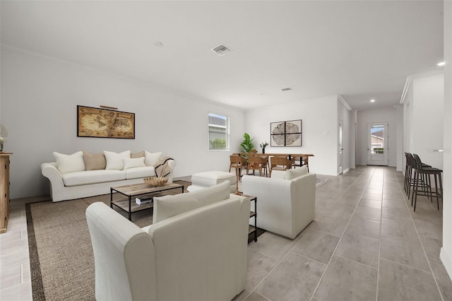 tiled living room featuring ornamental molding