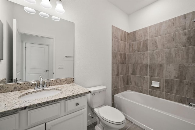 full bathroom featuring tile patterned flooring, vanity, tiled shower / bath combo, and toilet