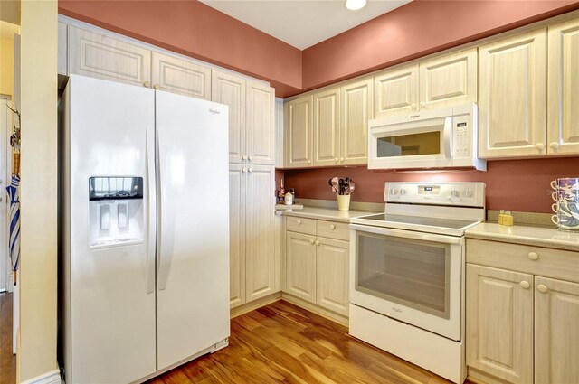 kitchen with white appliances, light wood-type flooring, and light countertops