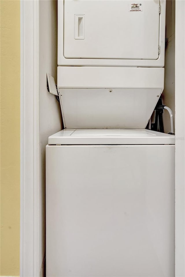 laundry area featuring stacked washer and clothes dryer