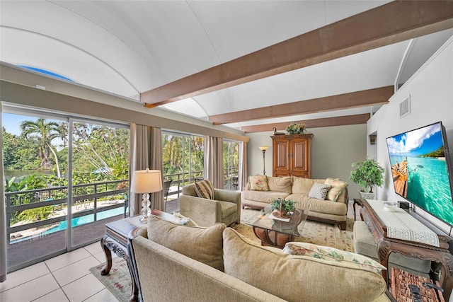 tiled living room featuring lofted ceiling with beams