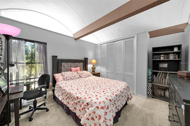 carpeted bedroom with a closet and vaulted ceiling with beams