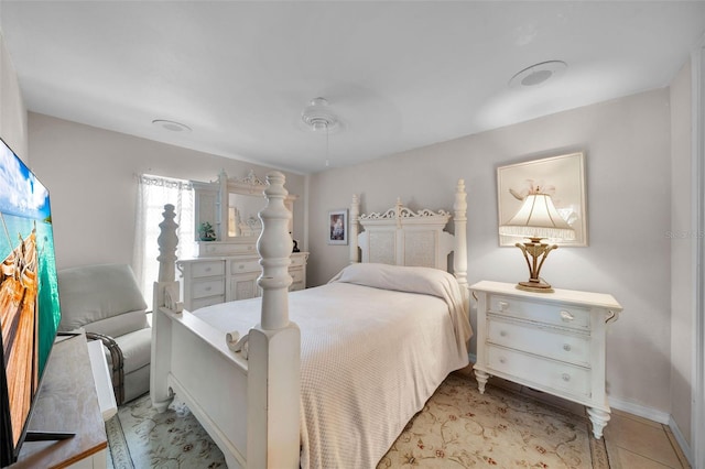 tiled bedroom featuring ceiling fan