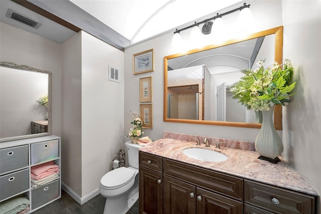 bathroom featuring vanity, toilet, and hardwood / wood-style flooring